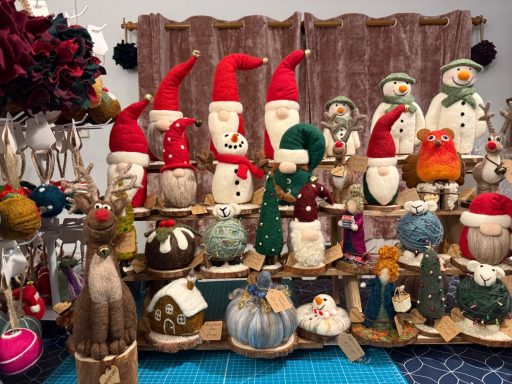 A display of festive decorative figures, including snowmen and gnomes, with various textures.