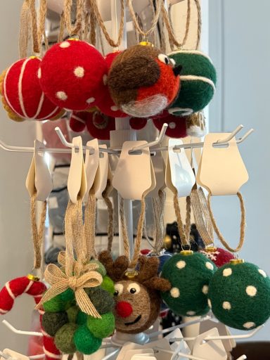 Colourful decorative felt ornaments, including a reindeer and green, red, and white balls.